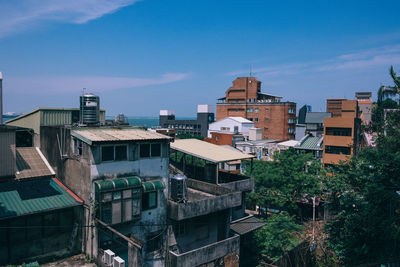 High angle view of buildings against blue sky