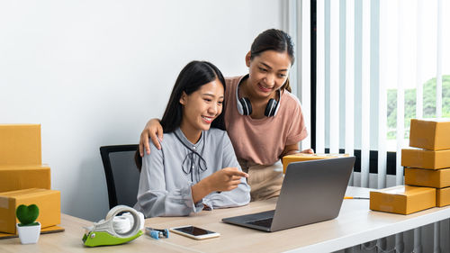 Businesswoman using laptop at office