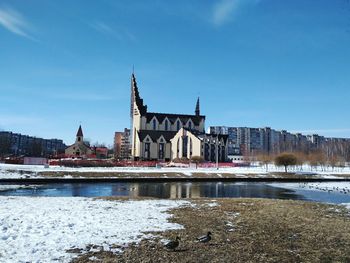 View of city at riverbank during winter