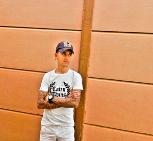 Full length of man standing against wall