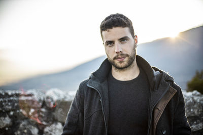 Portrait of young man standing outdoors