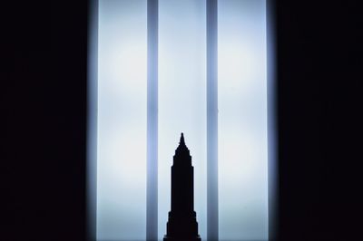 Silhouette of building against sky during foggy weather