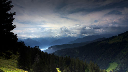 Panoramic view of trees and mountains against sky