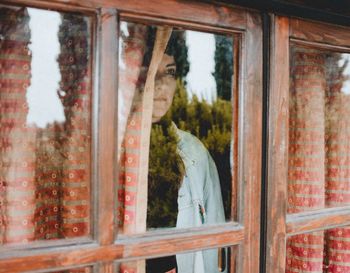 Reflection of man on glass window