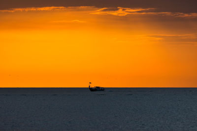 Scenic view of sea against orange sky