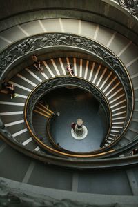 High angle view of people walking on spiral stairs