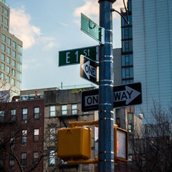 Close-up of road sign against built structure