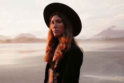 Beautiful, stylish woman on cox bay beach in tofino