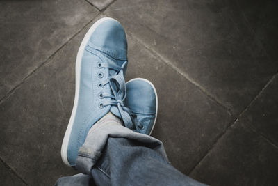 Low section of man skateboarding on floor