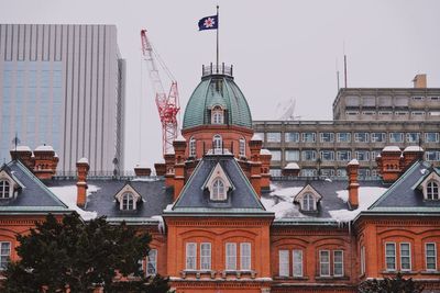 Buildings in city against sky