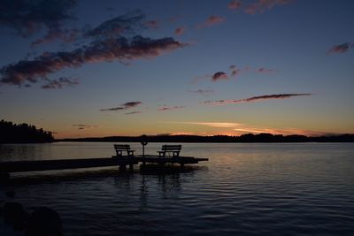 Pier in sea at dusk