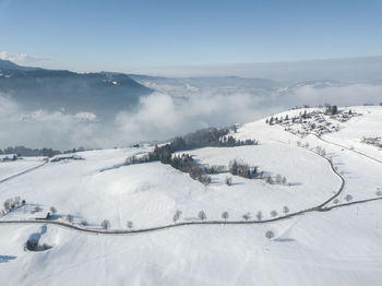 Scenic view of snow covered mountains against sky