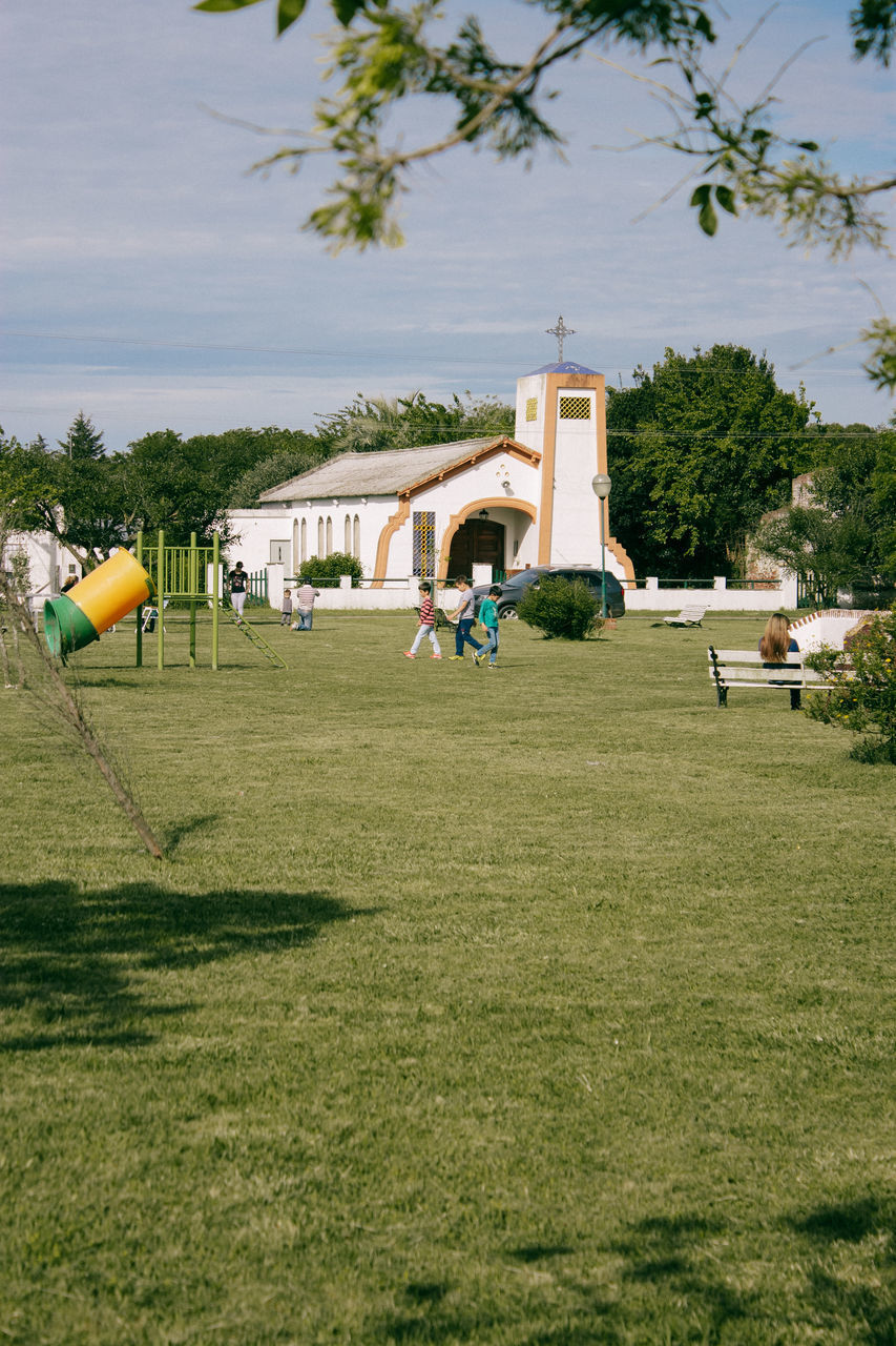 PEOPLE PLAYING SOCCER ON GOLF COURSE