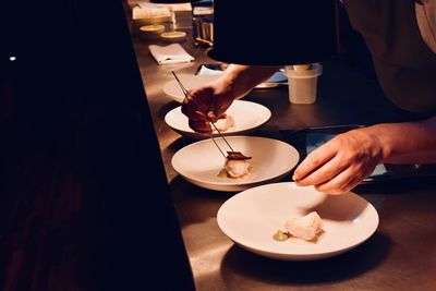 High angle view of man preparing food on table