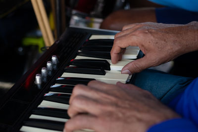 Detail of a hand playing the keyboard at an event. professional musician.