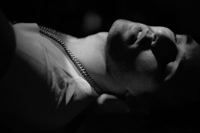 Close-up of man sleeping at night