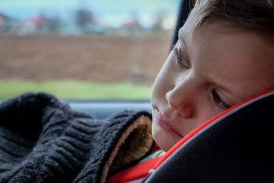 Close-up of child in car