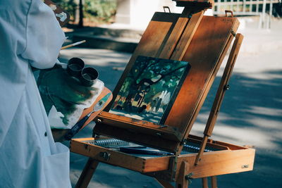 Man with umbrella on table by sea