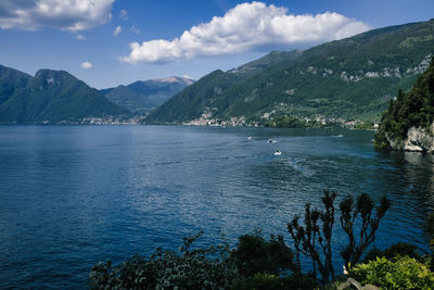 Scenic view of sea and mountains against sky