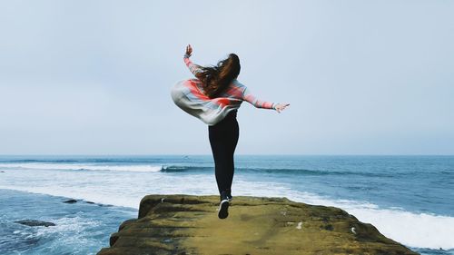 Woman jumping on beach