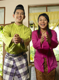 Portrait of smiling couple gesturing at home