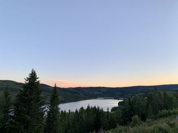 Scenic view of landscape against clear sky during sunset