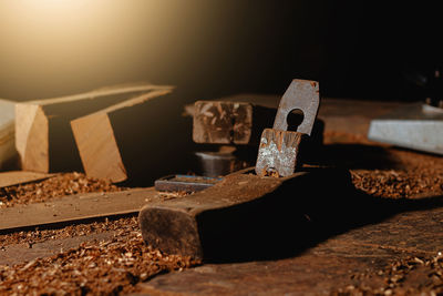 Close-up of a carpenter using a circular saw or a tool to cut wooden planks to make furniture  