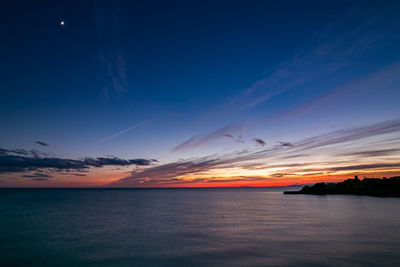 Scenic view of sea against romantic sky at sunset