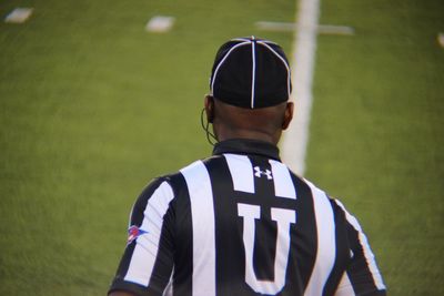 Rear view of man standing on field