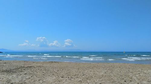 Scenic view of beach against blue sky