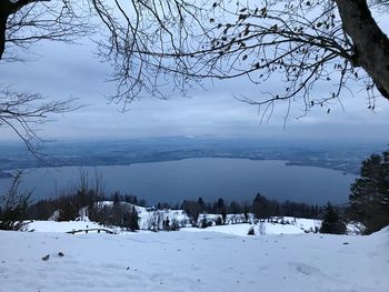 Scenic view of lake against sky during winter