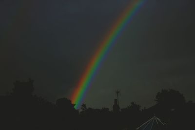 Rainbow over trees against sky