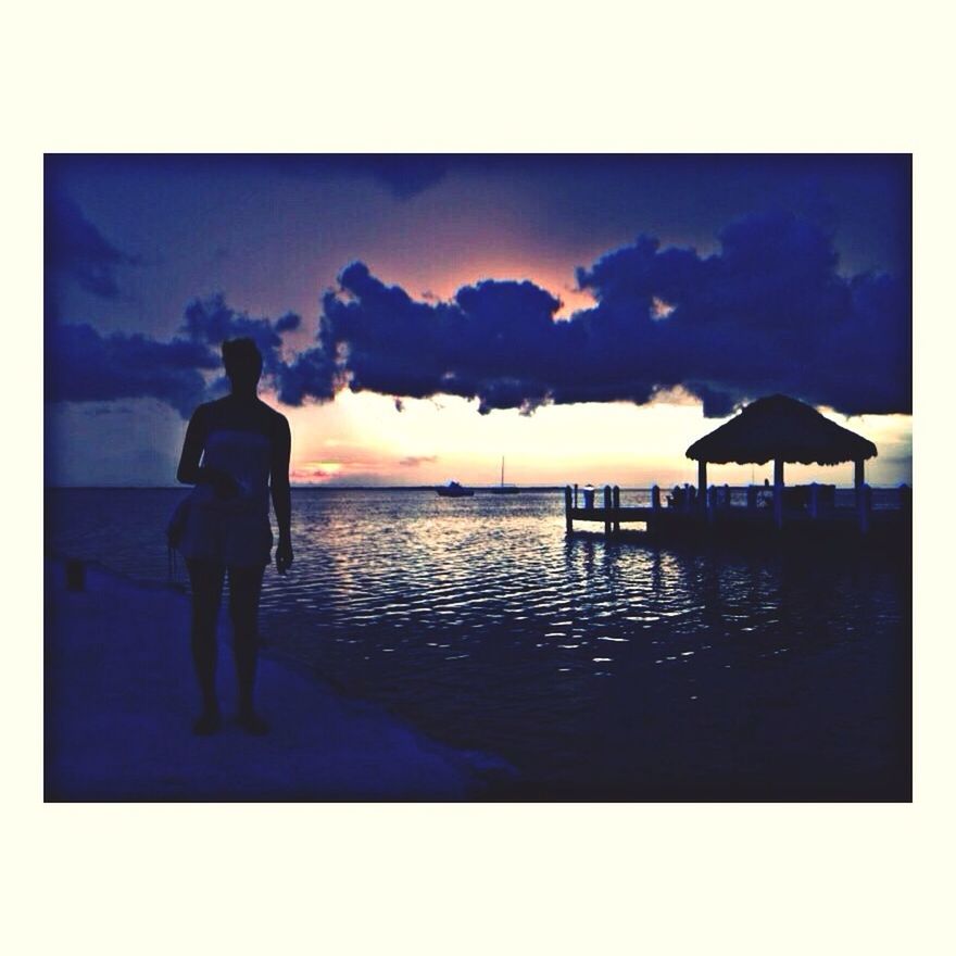 water, sea, transfer print, sky, horizon over water, auto post production filter, silhouette, lifestyles, beach, cloud - sky, standing, leisure activity, full length, shore, men, sunset, scenics, beauty in nature