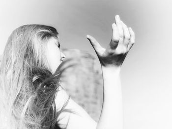 Portrait of woman with hair against white background