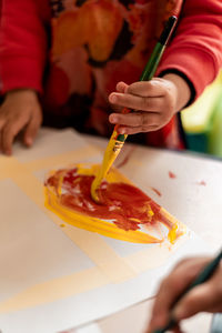 High angle view of girl drawing on table