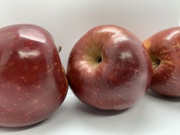 Close-up of wet apple on white background