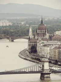 High angle view of bridge over river by buildings