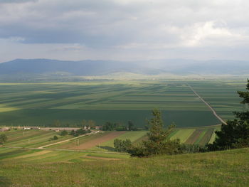 Scenic view of landscape against cloudy sky