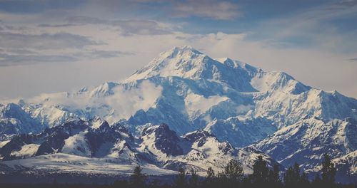 Scenic view of snowcapped mountains against sky