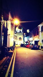 Cars on road in city at night