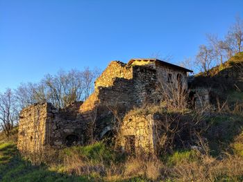 Old ruin building against clear blue sky