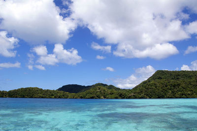 Scenic view of sea and mountains against sky