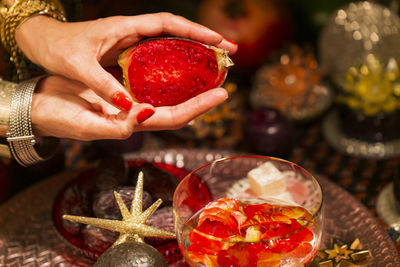 Close-up of hand holding strawberries