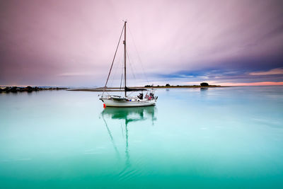 Sailboat in sea against sky