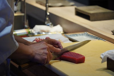 Cropped hand of man working on table