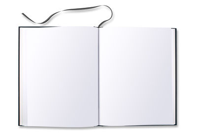 Directly above shot of open book against white background