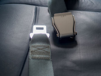 Close-up of seat belts in airplane