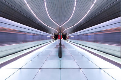 Diminishing perspective of illuminated railroad station platform