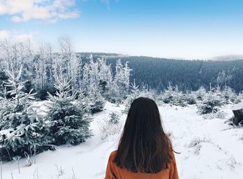 Rear view of woman on snow covered land