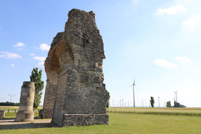 Rock formations on field against sky